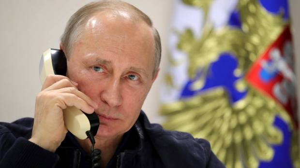 Russian President Vladimir Putin speaks on the phone aboard the Pioneering Spirit pipeline-laying ship in the Black Sea near Anapa, Russia, on Friday. CIA knew in August that Putin sought to boost Trump: report