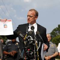 FBI Special Agent in Charge Tim Slater holds up a flyer looking for information about the deceased suspect James T. Hodgkinson, during a media availability Wednesday in Alexandria, Virginia. The rifle-wielding attacker opened fire on Republican lawmakers as they practiced for a charity baseball game, critically wounding House GOP Whip Steve Scalise of Louisiana and hitting aides and Capitol police as congressmen and others dove for cover. U.S. House majority whip shot at congressional baseball practice