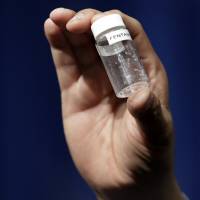 A reporter holds up an example of the amount of fentanyl that can be deadly after a news conference about deaths from fentanyl exposure, at DEA Headquarters in Arlington, Virginia, Tuesday. U.S. drug overdose deaths soared 19% to 59,000 in 2016 amid opioid scourge: report