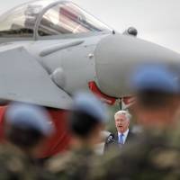 Britain’s Defense Minister Michael Fallon speaks backdropped by a RAF Typhoon fighter jet at the Mihail Kogalniceanu air base in Romania,Wednesday,. Fallon praised Romanian and British pilots for protecting the Black Sea region from “the persistent threat of Russian aggression,” saying that Britain remains committed to NATO and the European security. U.K. defense chief Fallon praises pilots for stopping 'Russian threat' in Black Sea