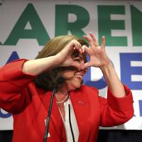 Republican House candidate Karen Handel makes a heart symbol during an early appearance to thank her supporters after the first returns came in at her election night party in the 6th District race with Jon Ossoff on Tuesday in Atlanta. Handel won the nationally watched congressional election, avoiding an upset that would have rocked Washington ahead of the 2018 midterm polls. Republican Karen Handel wins Georgia House seat in key contest