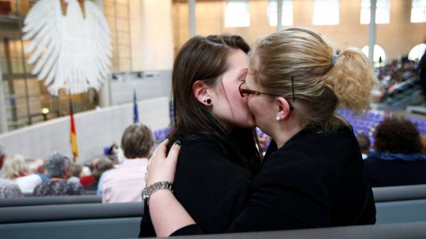 A couple kiss after the Bundestag voted on legalizing same-sex marriage in Berlin on Friday. Germany passes same-sex marriage law