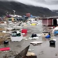 Grab taken from a video shows houses close to Nuugaatsiag, Greenland, flooded by ttsunami Sunday. Meteorologists saw the waves as likely to have resulted from an overnight temblor measuring magnitude-4 at Uummannaq, a small town sitting well above the Arctic circle. Four missing in tsunami-hit Greenland village after M4 temblor