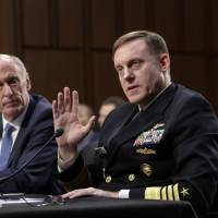 National Security Agency Director Adm. Mike Rogers, joined by Director of National Intelligence Dan Coats, testifies before the Senate Select Committee on Intelligence about gathering intelligence on foreign agents, on Capitol Hill in Washington Wednesday. Two intel chiefs refuse to say if they were pressured by Trump to ease Russia probes
