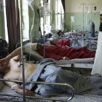 Wounded men lie on their beds in Wazir Akbar Khan Hospital in Kabul Wednesday. A massive explosion rocked a highly secure diplomatic area of Kabul on Wednesday morning, causing a big number of casualties and sending a huge plume of smoke over the Afghan capital. Civilians scour Kabul hospitals, morgues seeking kin after suicide tanker bombing kills 90
