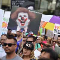 Members of the LGBT community and their supporters participate in the Los Angeles Gay Pride Resist March Sunday in Hollywood, California. The Resist March is being held in conjunction with the LGBT Equality March for Unity & Pride parade in Washington. Thousands partake in LGBT rights marches across U.S. to fete gains