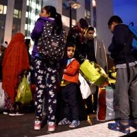 Residents are evacuated from the Taplow Tower residential block as a precautionary measure following concerns over the type of cladding used on the outside of the building on the Chalcots Estate in north London on Friday. London council evacuates residents over fire safety concerns
