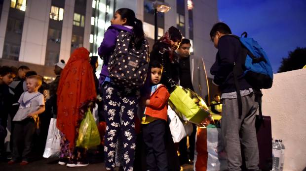 Residents are evacuated from the Taplow Tower residential block as a precautionary measure following concerns over the type of cladding used on the outside of the building on the Chalcots Estate in north London on Friday. London council evacuates residents over fire safety concerns