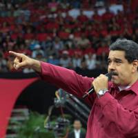 Venezuelan President Nicolas Maduro speaks during a gathering in support of him and his proposal for the National Constituent Assembly in Caracas Tuesday. Maduro says chopper fired on Venezuela's Supreme Court