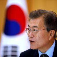 South Korean President Moon Jae-in speaks during an interview with Reuters at the Presidential Blue House in Seoul Thursday. Moon calls on Xi to do more to thwart North Korea's nuclear program, voices concern over Japan's defense spending