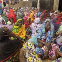 Women mourn following a fatal attack by five female suicide bombers in a village near Maiduguri, Nigeria, on Monday. 1 million Nigerian farmers given seeds to avert famine in region hit by Boko Haram