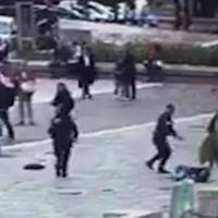 In this image taken from video of CCTV footage provided to AP on the condition that its source not be revealed a French policeman (standing right) points his gun at an attacker, on the ground, after the attacker hit the policeman with a hammer outside Notre Dame Cathedral in Paris on Tuesday. A French government spokesman says that the man who attacked police officers patrolling in front of Notre Dame Cathedral, crying out “This is for Syria!,” was a student working on his doctoral thesis who showed no signs of radicalization. Notre Dame attacker was pro-democracy ex-journalist, student; flat yields video of allegiance to Islamic State
