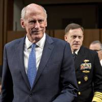 Director of National Intelligence Dan Coats (left) and National Security Agency Director Michael Rogers arrive for a Senate Intelligence Committee hearing on Wednesday. NSA backtracks on disclosing how many Americans are caught up in warrantless spying