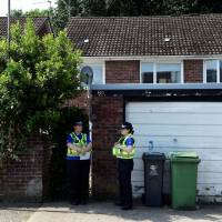 Police officers stand outside the home of Darren Osborne, in Cardiff, Wales, Tuesday. Osborne has been named by British media as the man suspected of driving a rented van into Muslim worshippers after they left prayers at a north London mosque. Accused London mosque attacker made anti-Muslim slurs, drank heavily, neighbors say