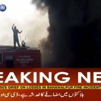 In this image taken from video on Sunday, smoke rises from an oil tanker that overturned and burst into flames as locals in Bahawalpur, Pakistan, were trying to collect the fuel. Oil tanker blast kills over 140 in Pakistan
