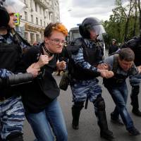 Riot police detain demonstrators during an anti-corruption protest organized by opposition leader Alexei Navalny, on Tverskaya Street in central Moscow Monday. Mass arrests reported as thousands across Russia protest corruption, confront Kremlin