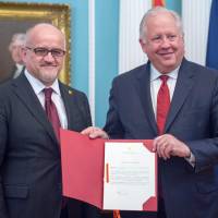 U.S. Deputy Secretary of State Tom Shannon displays the instrument of accession to NATO alongside Montenegro Foreign Minister Srdjan Damanovic (left) during a ceremony at the State Department in Washington on June 5. Russia cancels fence-mending meeting with U.S. after Washington expands sanctions over Ukraine