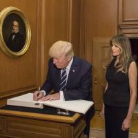 President Donald Trump, accompanied by first lady Melania Trump, signs the Supreme Court guest book Thursday at the Supreme Court in Washington. The Supreme Court held a special sitting for the formal investiture ceremony of Associate Justice Neil Gorsuch as he took the oaths of office to become the 101st Associate Justice of the Supreme Court of the United States. Trump visits Supreme Court for Gorsuch ceremony as justices weigh travel ban