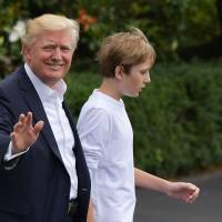 U.S. President Donald Trump and son Barron make their way to board Marine One on the South Lawn of the White House on Saturday in Washington. Trump is heading to the Camp David presidential retreat where he was due to spend the weekend. Trump still tweets 'Witch Hunt' but attorney says president isn't under investigation