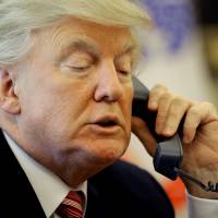 U.S. President Donald Trump waits on the line as he calls Prime Minister Leo Varadkar of Ireland to congratulate him for his victory, at the Oval Office of the White House in Washington Tuesday. Trump's politicking, campaigning for 2020 raise ethics flags