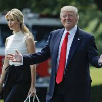U.S. President Donald Trump smiles as he walks with his daughter Ivanka across the South Lawn of the White House in Washington on Tuesday before boarding Marine One helicopter for the trip to nearby Andrews Air Force Base. U.S. lawmakers sue Trump over foreign state payments to businesses