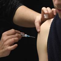 A French student is vaccinated at the University of Dijon on Jan. 4. EU rules courts can link illness to vaccines without evidence