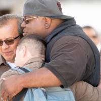 UPS workers hug at the scene where a gunman shot and killed multiple people including himself at a UPS facility in San Francisco Wednesday. UPS worker kills three co-workers then himself at San Francisco warehouse