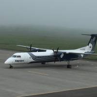 A charter flight sits on the tarmac at Nakashibetsu airport as a planned trip to the Russian-held islands off Hokkaido was canceled due to heavy fog. Canceled flight leaves former residents of Russian-held isles stranded
