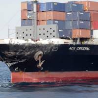 In this Saturday photo released by Japan’s 3rd Regional Coast Guard Headquarters, the damaged Philippine-registered container ship ACX Crystal is seen off the Izu Peninsula, southwest of Tokyo. Japanese investigators obtain data recorder of freighter that collided with U.S. destroyer