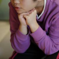 A 9-year-old girl who spent more than three months in a temporary shelter in Tokyo after being reported as a victim of abuse sits in her psychotherapist’s office in Tokyo on March 17. Japan's shelters provide little comfort to abused children