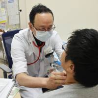 A boy undergoes a thyroid cancer test at a hospital. The Fukushima Prefectural Government said seven more residents who were aged 18 or under at the time of the 2011 nuclear disaster have been found to have thyroid cancer. Seven more Fukushima residents diagnosed with thyroid cancer