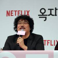 South Korean director Bong Joon-ho, left, and actress Tilda Swinton attend at the press conference for their latest film “Okja” in Seoul on Wednesday. South Korean director urges new rules over Netflix movies at theaters