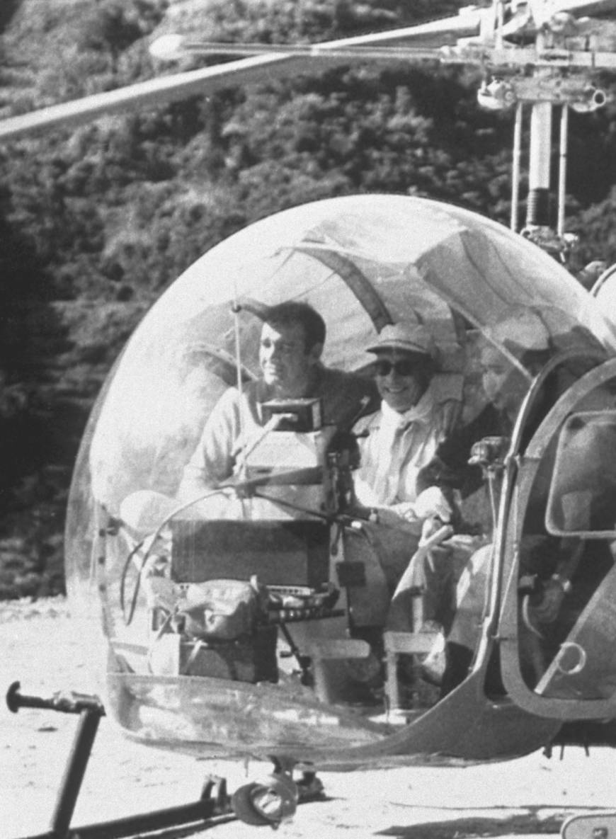 Sean Connery (left) sits in a helicopter on the set of