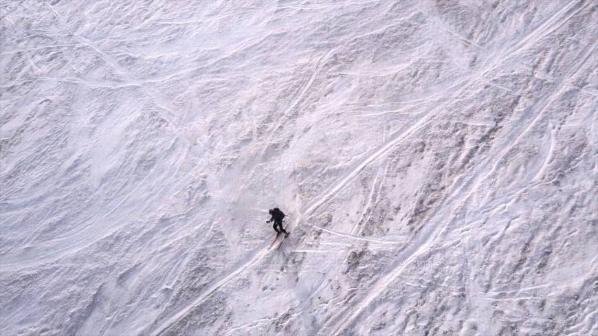 Heading home in style: The author makes his daring descent on skis.