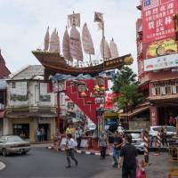 Not-so-subtle: A replica of one of the treasure ships of Zheng He sits above a street in Malacca, Malaysia, where the Chinese admiral first landed over 600 years ago. 'Everything Under the Heavens: How the Past Helps Shape China's Push For Global Power': Waking up to China's dream of holding court