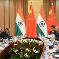 Indian Prime Minister Narendra Modi (left) and Chinese President Xi Jinping (right) meet in the Kazakhstan capital of Astana on June 9. China’s fast-growing trade surplus with India has increased Xi ‘s territorial assertiveness. Countering China's high-altitude land grab