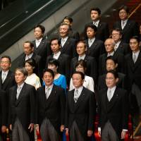 Prime Minister Shinzo Abe (front center) poses with members of his new Cabinet on Aug. 3 after the latest reshuffle. Which members of the Abe Cabinet deserve to be fired?