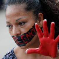 An activist takes part in a demonstration against the killing of Mexican journalists in Mexico City on May 30. The words painted across her face read: “No to Silence.” Since 1992, 41 Mexican journalists have been killed and another 50 have died in murky circumstances. Mexico's most dangerous profession