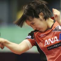 Miu Hirano hits a shot during her match against Chen Meng in the Japan Open quarterfinals on Saturday. Below: Hirano reacts during her 7-11, 8-11, 5-11, 7-11 loss. Hirano vows to face up to Chinese challenge