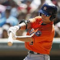 The Astros’ Norichika Aoki hits a sacrifice fly in the seventh inning on Wednesday against the Twins at Target Field. Astros slug six home runs in rout of Twins