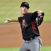 The Diamondbacks’ Zack Greinke pitches against the Marlins on Thursday in Miami. Greinke does it all as D-Backs edge Marlins