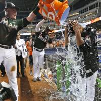 Edinson Volquez is doused with water by two of his teammates after throwing the first no-hitter of his career on Saturday in Miami. Marlins' Volquez fires no-hitter agianst Diamondbacks