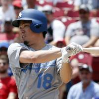 The Dodgers’ Kenta Maeda hits a two-run double against the Reds on Sunday in Cincinnati. Los Angeles won 8-7. Maeda has good day on mound, at plate in Dodgers' win over Reds