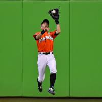 Ichiro Suzuki makes a catch in center field during the Marlins’ win over the Cubs on Sunday in Miami. Ichiro becomes oldest ever to start in center