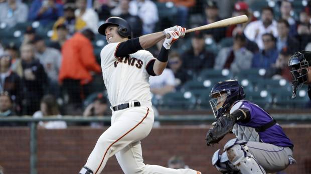 San Francisco’s Buster Posey strokes an RBI double against Colorado in the first inning on Monday night. Giants pound Rockies, end five-game slide