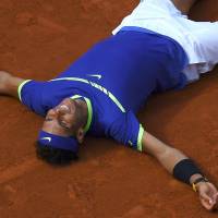 Rafael Nadal celebrates after the final point of his victory over Stan Wawrinka in the French Open final on Sunday in Paris. Nadal routs Wawrinka to capture record 10th title at French Open