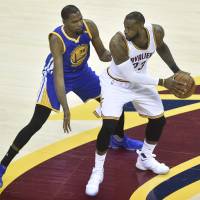 The Cavaliers’ LeBron James looks to get past the Warriors’ Kevin Durant in the first quarter of Game 3 on Wednesday in Cleveland. Durant drains late 3-pointer to sink Cavaliers as Warriors move within win of title