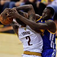 Warriors forward Draymond Green (right) contests a shot attempt by Cavaliers guard Kyrie Irving during Game 4 of the NBA Finals on Friday. Warriors head to Game 5 with Green in tow