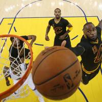 Cleveland’s LeBron James reaches for a rebound during Game 5 of the NBA Finals on Monday. Dethroned Cavs look for answers