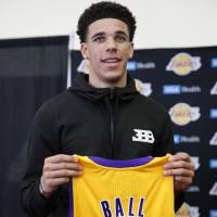 Lonzo Ball, who was selected as the No. 2 pick in the NBA Draft by the Los Angeles Lakers on Thursday, poses with his jersey after a news conference at the team’s practice facility on Friday. Magic counting on Ball to turn around lame Lakers